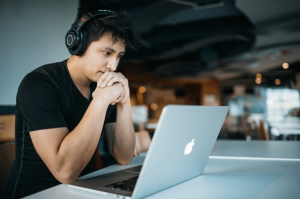 man with headphones at his laptop