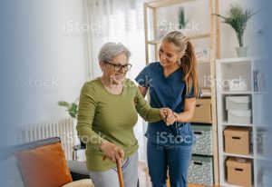 a woman helping an older woman walk