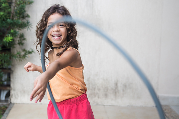 Child playing with a hoola hoop