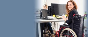 woman in wheelchair at her computer