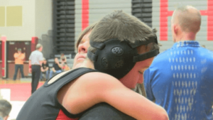 young wrestlers hugging